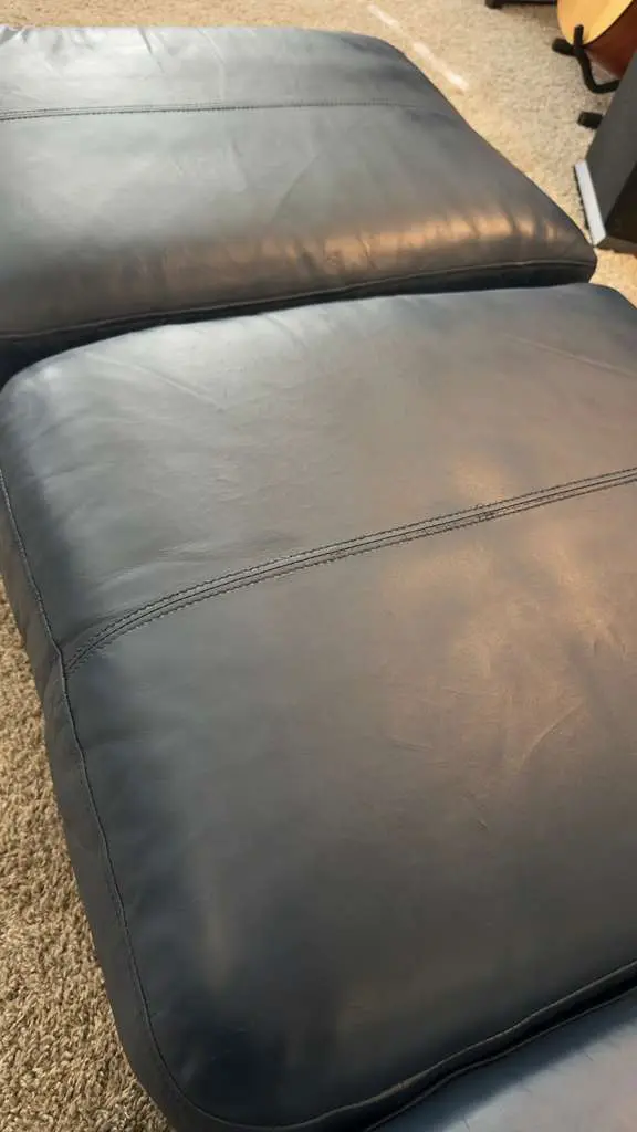 A richly recoloured brown leather cushion, smooth and conditioned