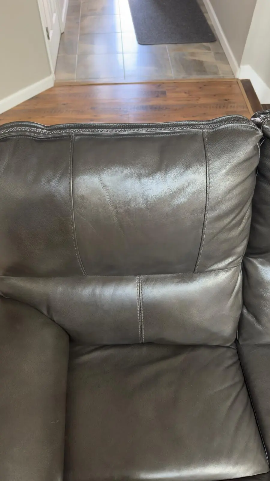 A richly recoloured brown leather cushion, smooth and conditioned