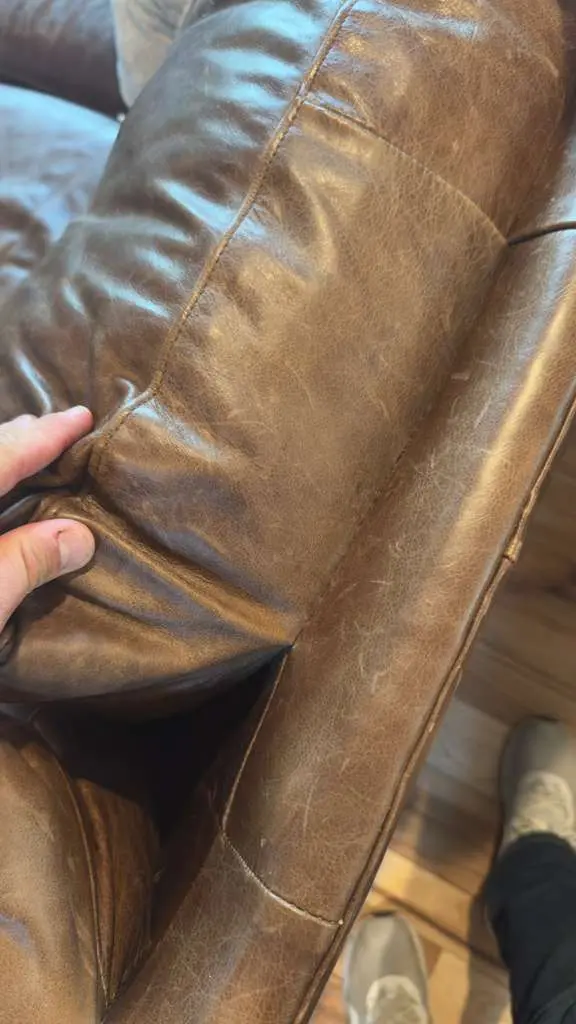 A richly recoloured brown leather cushion, smooth and conditioned