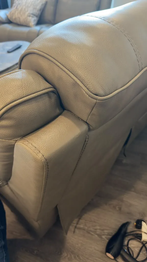A richly recoloured brown leather cushion, smooth and conditioned