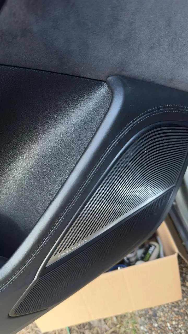 The same door panel refinished to a deep, uniform black