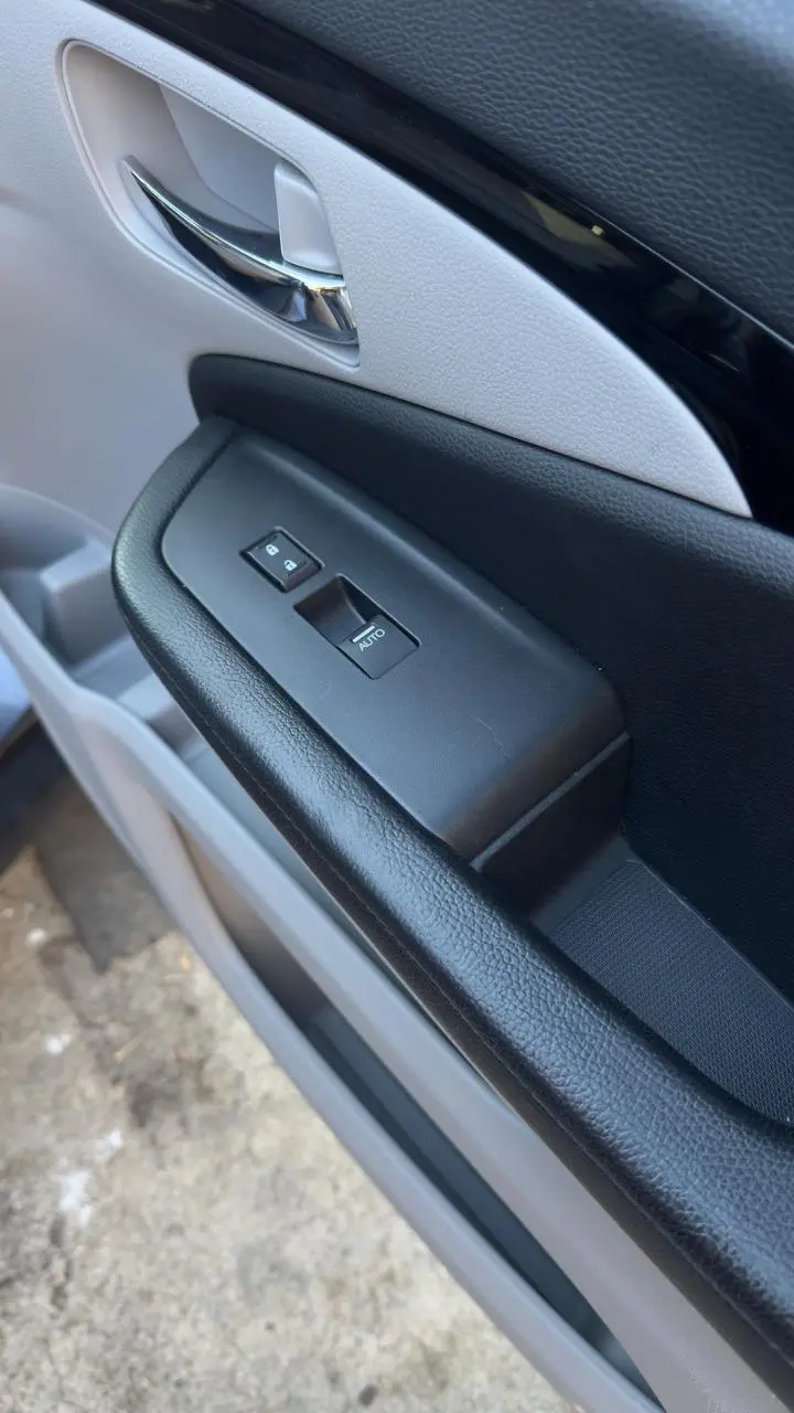 A cleanly refinished door card with intact grain and switchgear